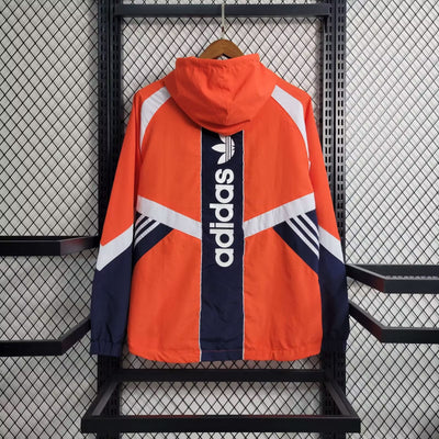 an orange and blue jacket hanging on a rack