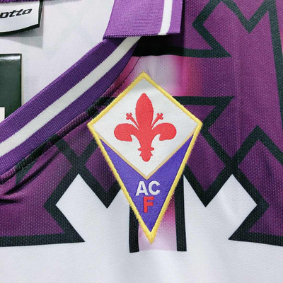 a close up of a soccer jersey with a badge on it