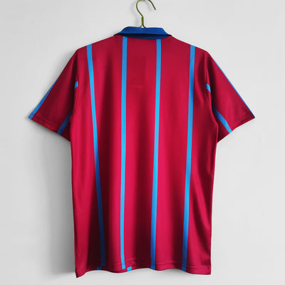 a red and blue striped shirt hanging on a wall