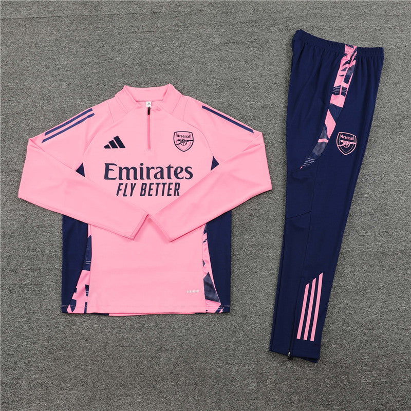 a pink and blue soccer uniform sitting on top of a floor