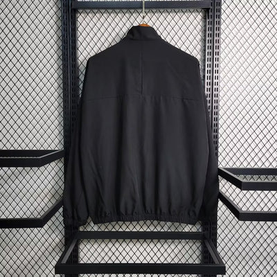 a black jacket hanging on a metal rack