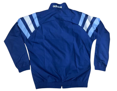 a blue jacket with white stripes on the sleeves