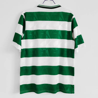 a green and white striped shirt hanging on a wall