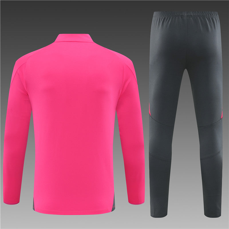 a pink and black soccer uniform and pants