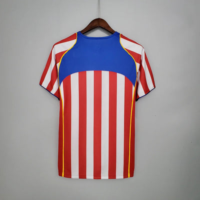 a red, white and blue shirt hanging on a hanger