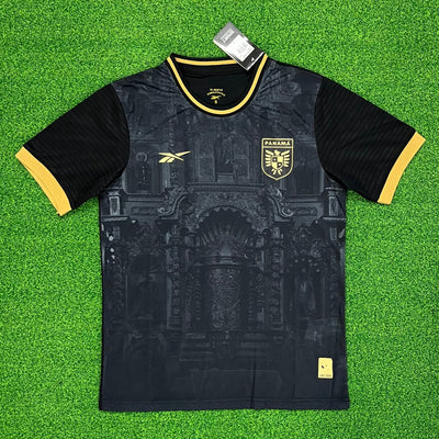 a black and yellow soccer jersey sitting on top of a green field