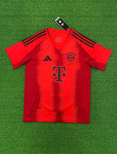 a red soccer jersey laying on a green field