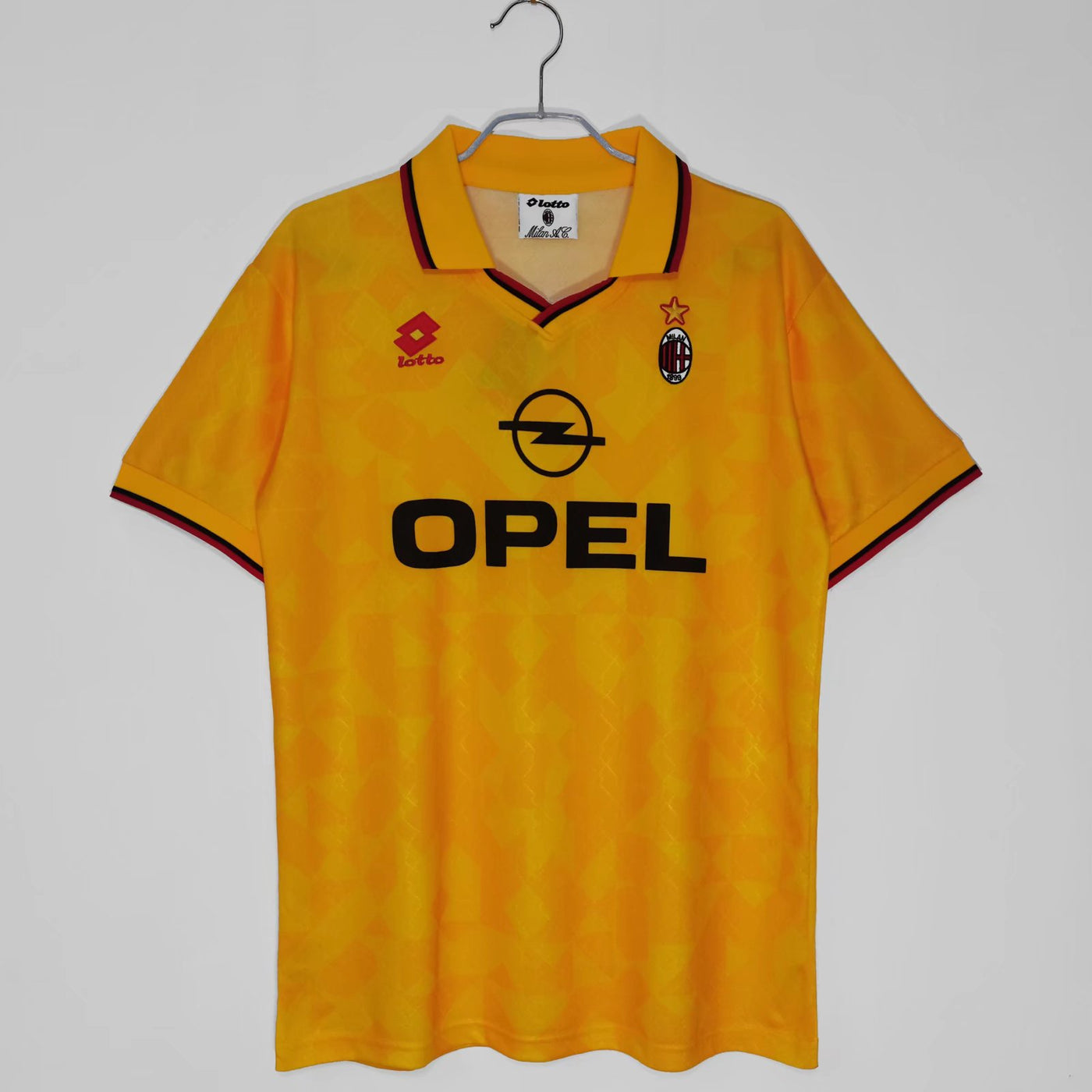 a yellow shirt hanging on a hanger