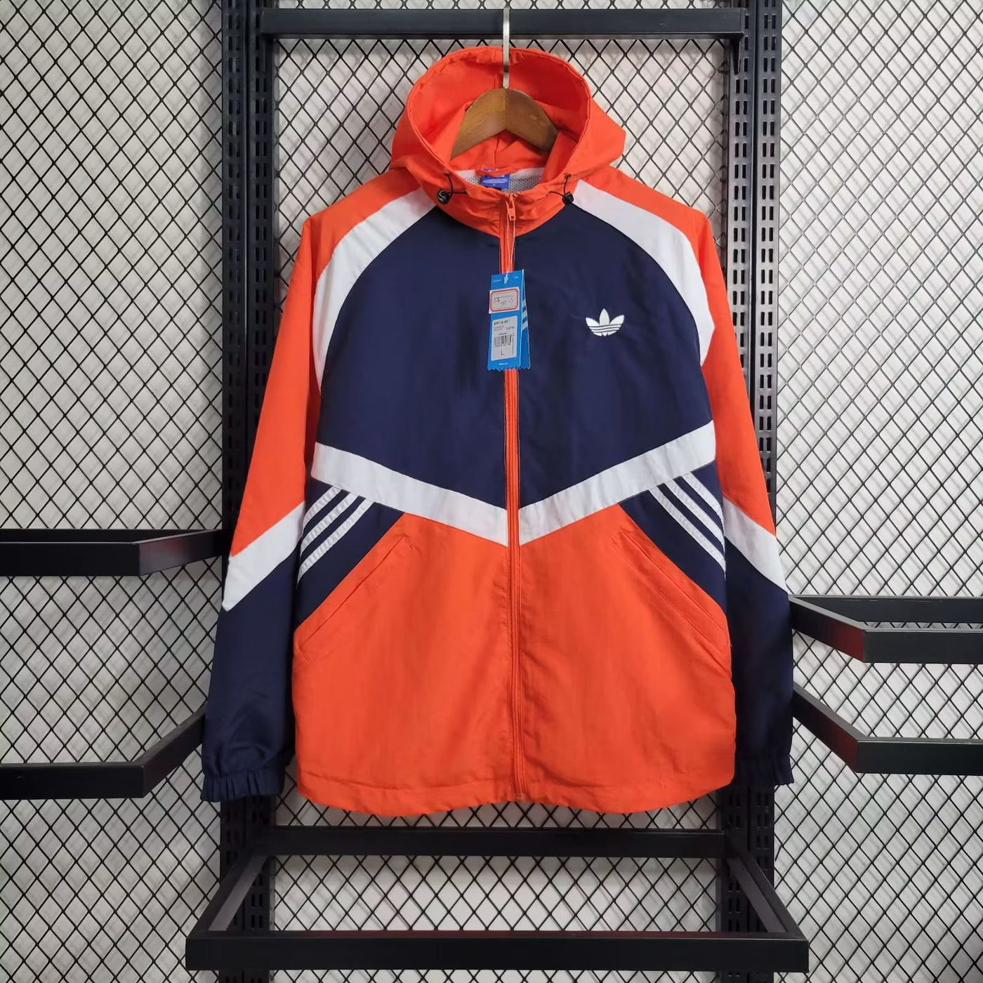 an orange and blue jacket hanging on a rack