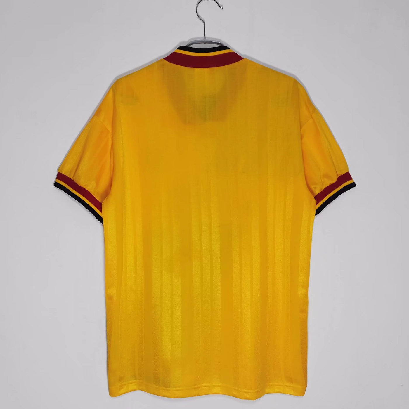 a yellow shirt hanging on a hanger