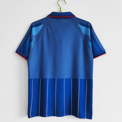 a blue t - shirt hanging on a hanger