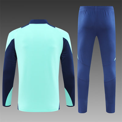 a blue and green soccer uniform and pants