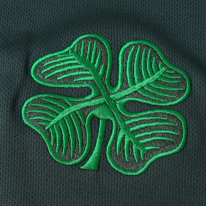 a four leaf clover embroidered on a green polo shirt