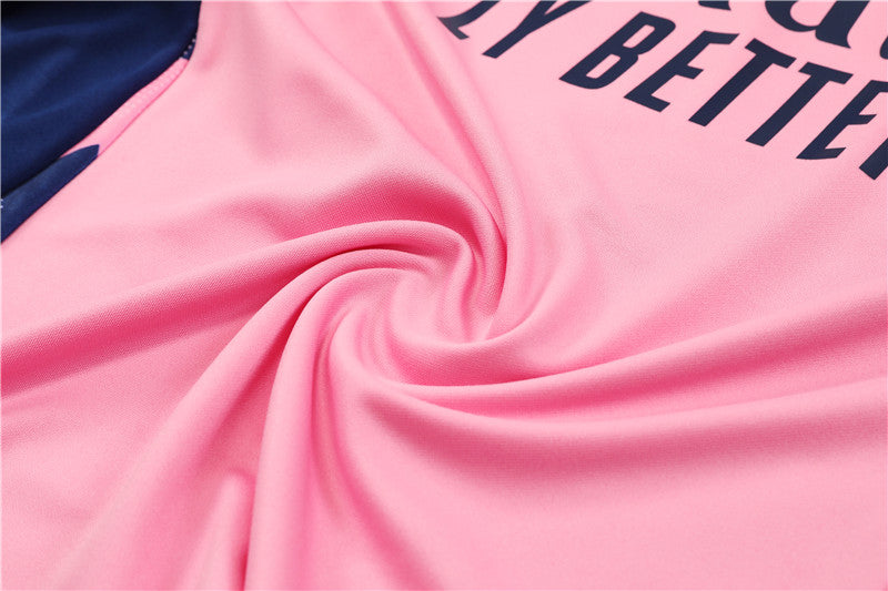 a close up of a pink and blue jersey