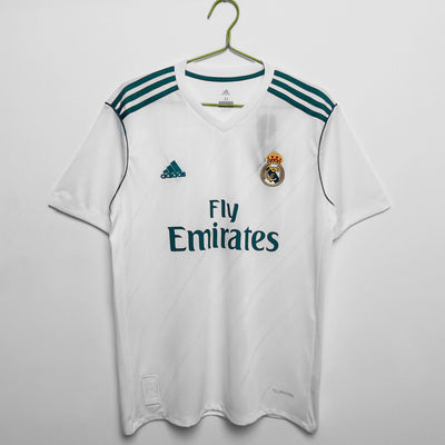 a real madrid jersey hangs on a hanger