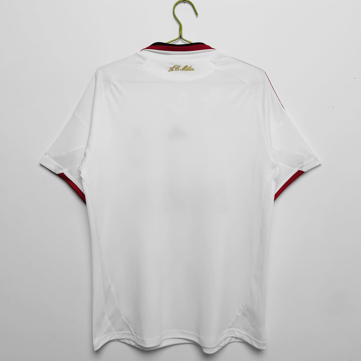 a white shirt hanging on a hanger