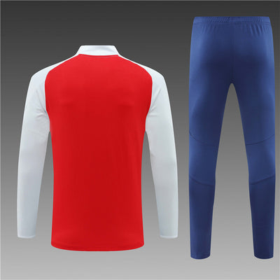 a red, white and blue soccer jersey and pants