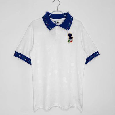 a white and blue polo shirt hanging on a hanger