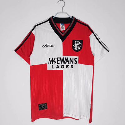 a red and white soccer jersey hanging on a hanger