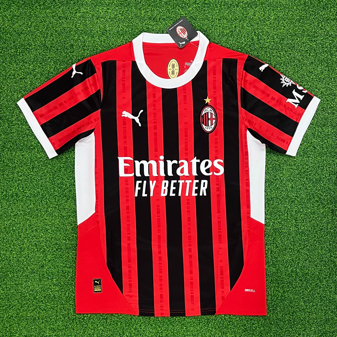 a black and red soccer jersey laying on a green field