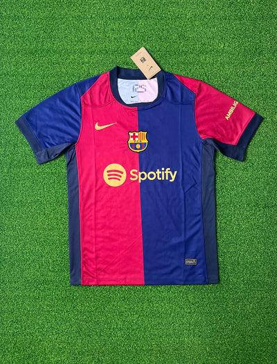 a purple and blue soccer jersey sitting on top of a green field