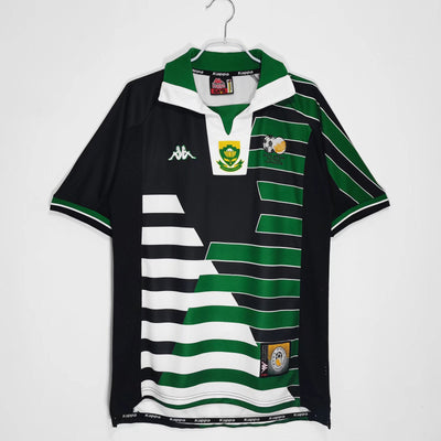 a green and black rugby shirt hanging on a hanger