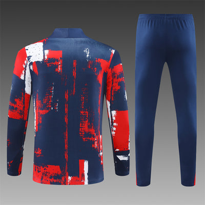 a man's blue and red tracksuit with red and white paint splat