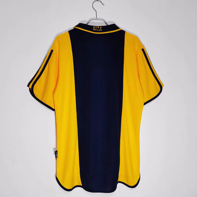 a yellow and blue shirt hanging on a hanger