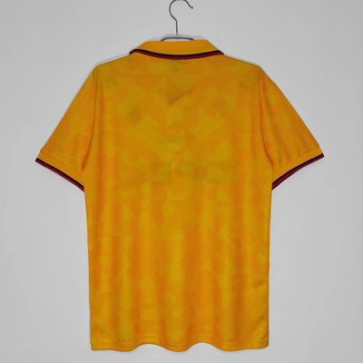 a yellow shirt hanging on a hanger