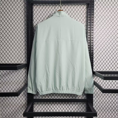 a light green jacket hanging on a rack