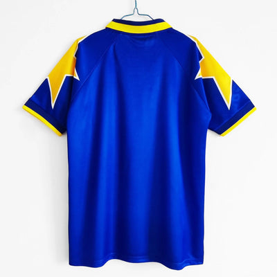 a blue and yellow shirt hanging on a wall