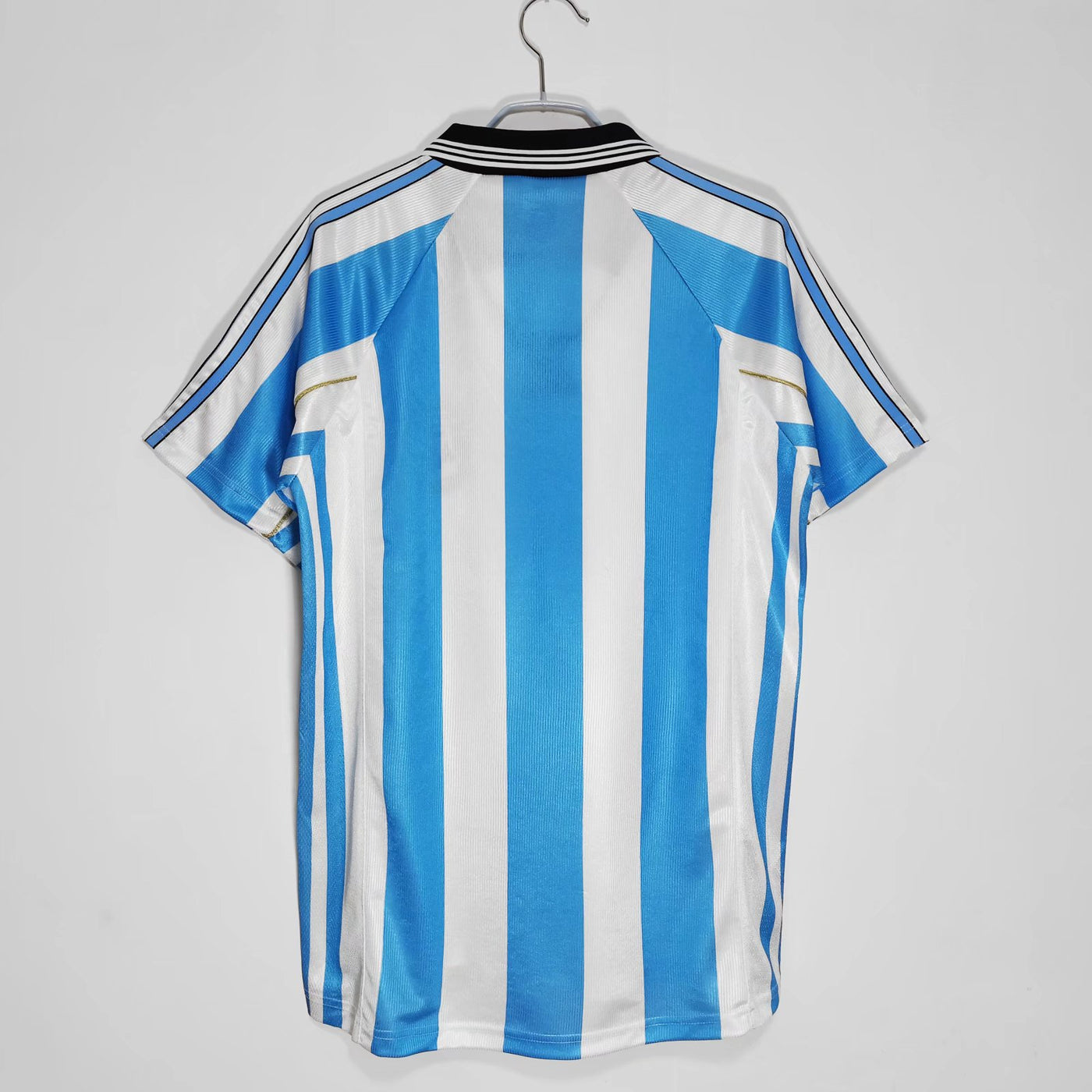 a blue and white striped shirt hanging on a hanger