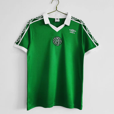 a green soccer jersey hanging on a hanger