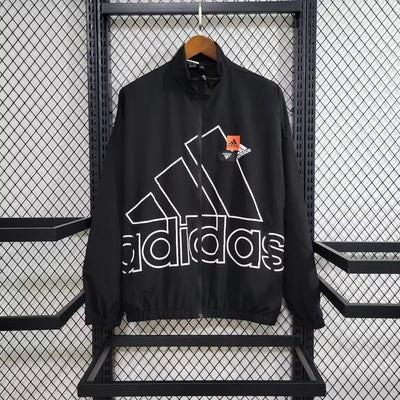 a black adidas jacket hanging on a rack