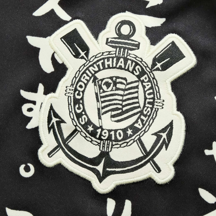 the back of a black and white jacket with an anchor and cross on it