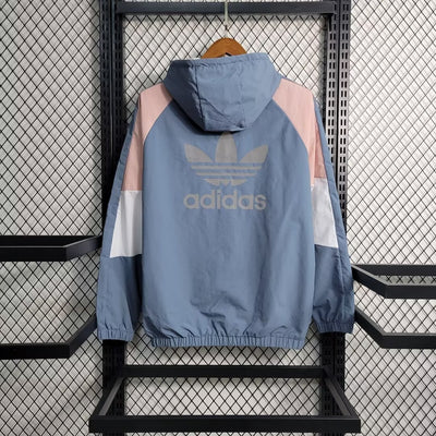 a blue adidas jacket hanging on a rack