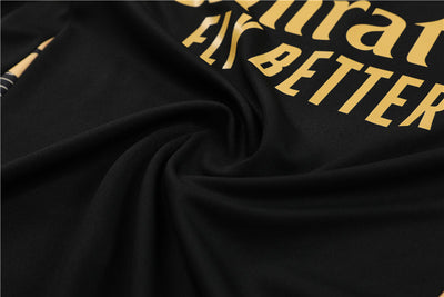 a close up of a black fabric with gold lettering