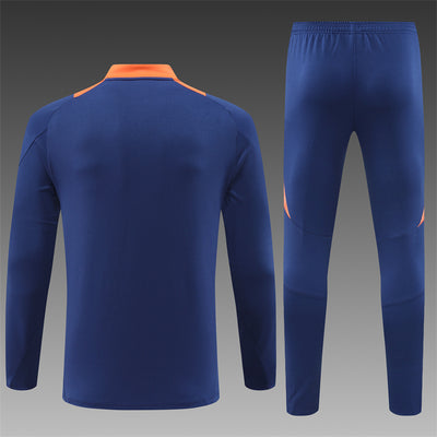 a blue soccer uniform with an orange stripe