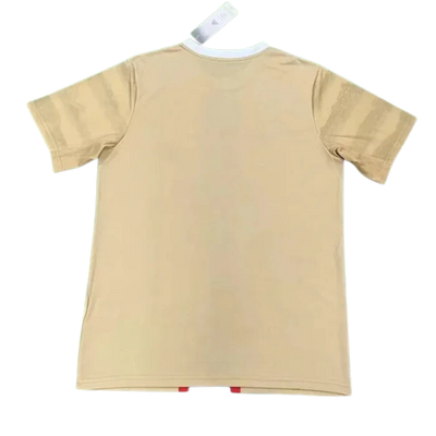 a tan t - shirt hanging on a clothes line