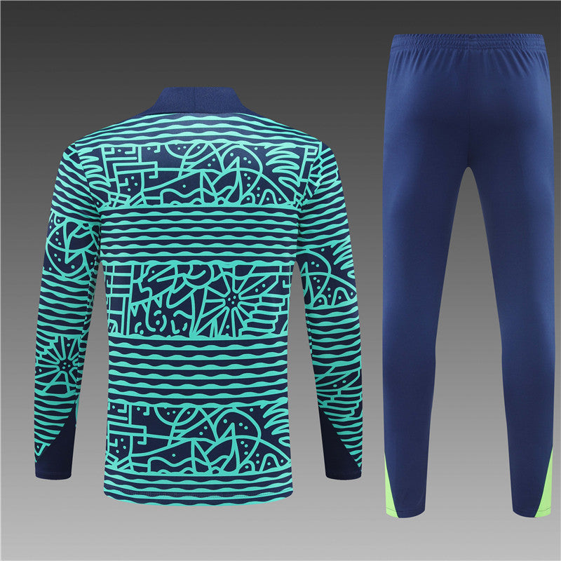 a man's tracksuit and pants with a blue and green pattern