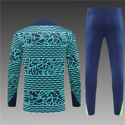 a man's tracksuit and pants with a blue and green pattern