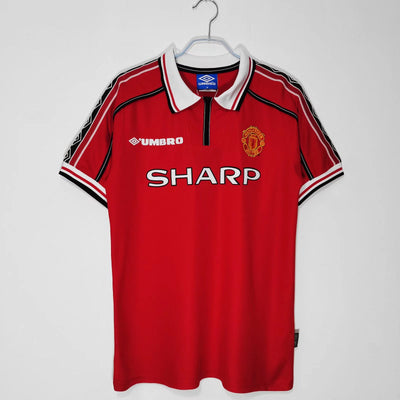 a manchester united shirt hanging on a hanger