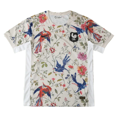 a white t - shirt with colorful birds and flowers on it