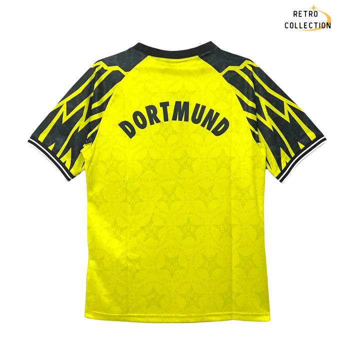 a yellow soccer jersey with black and yellow lettering