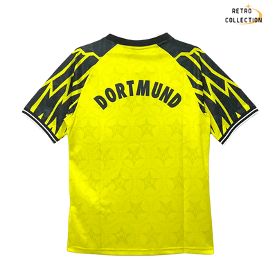 a yellow soccer jersey with black and yellow lettering