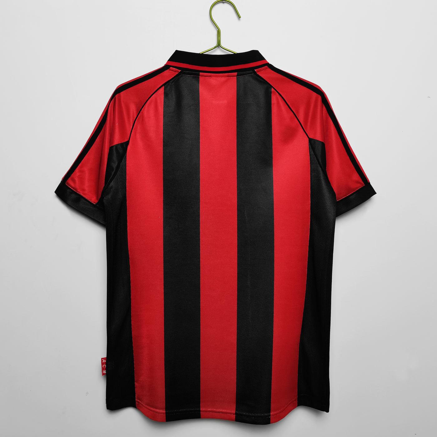 a red and black striped shirt hanging on a hanger