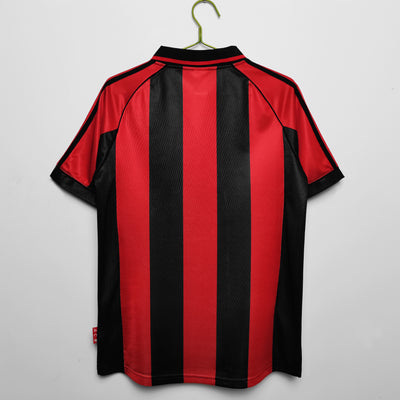 a red and black striped shirt hanging on a hanger