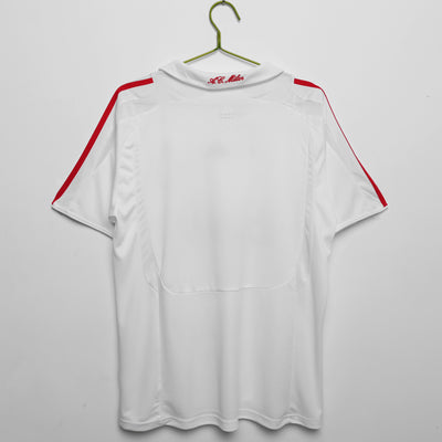 a white shirt hanging on a hanger