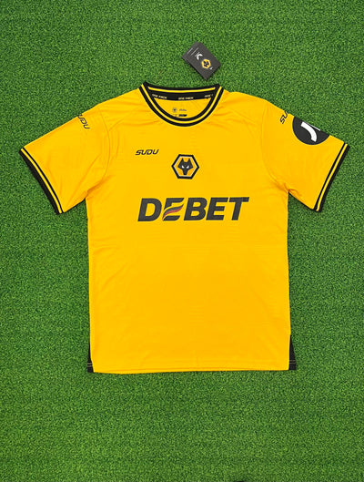 a yellow soccer jersey laying on a green field