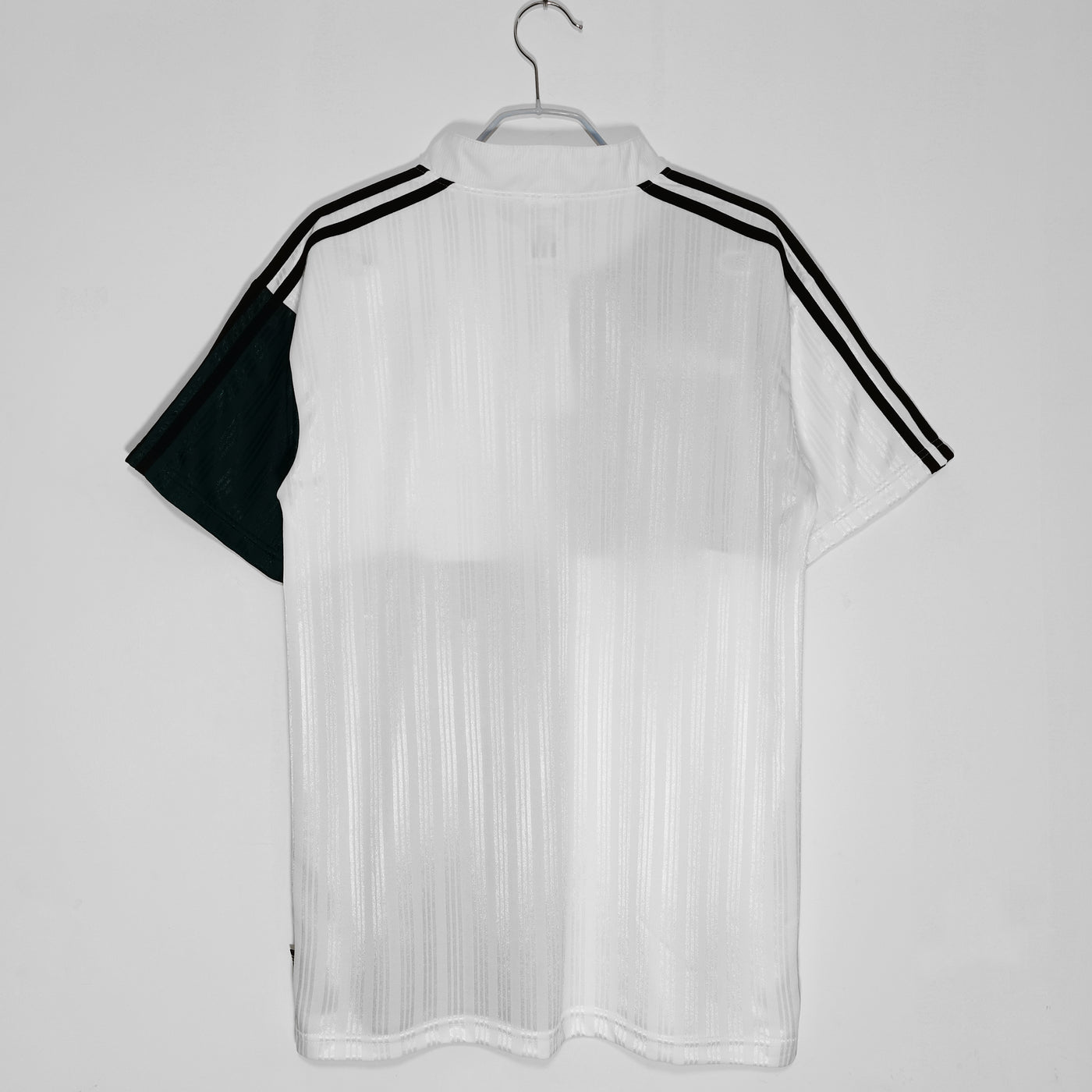 a black and white shirt hanging on a hanger